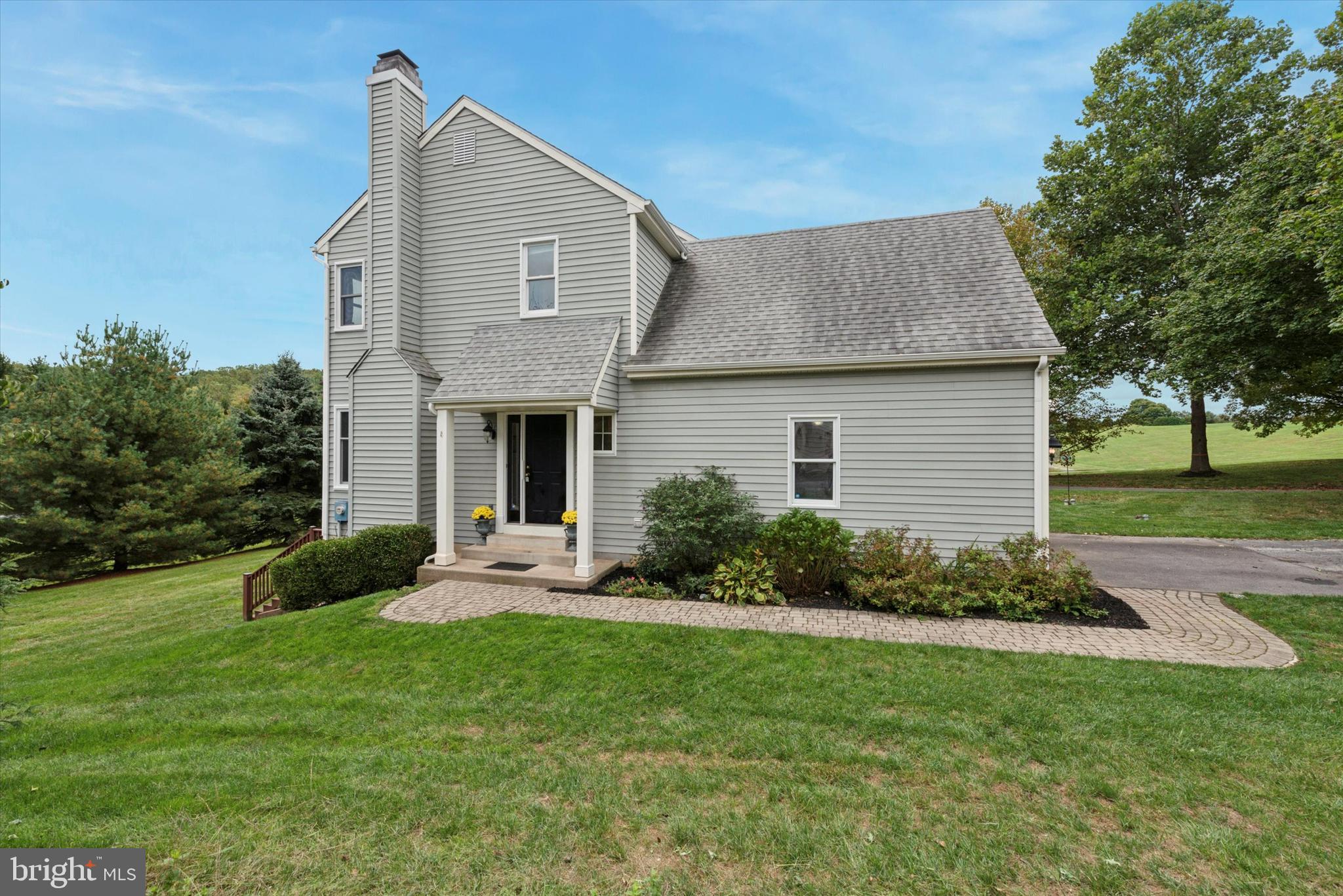 a front view of house with yard and green space