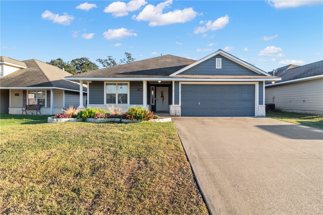 Ranch-style home featuring a front yard, central A