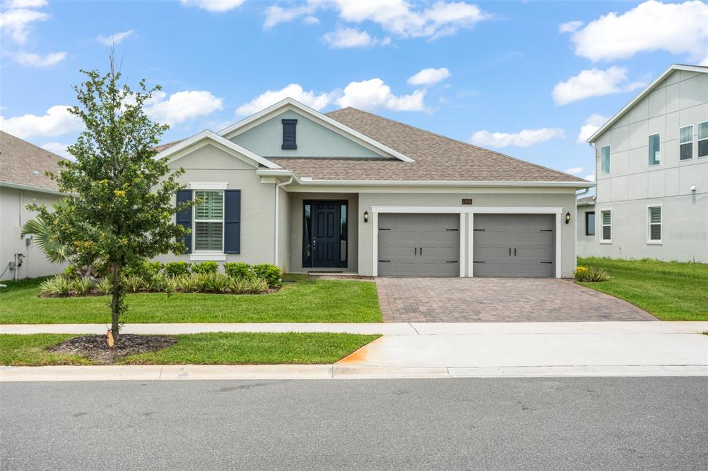 a front view of a house with a yard and garage