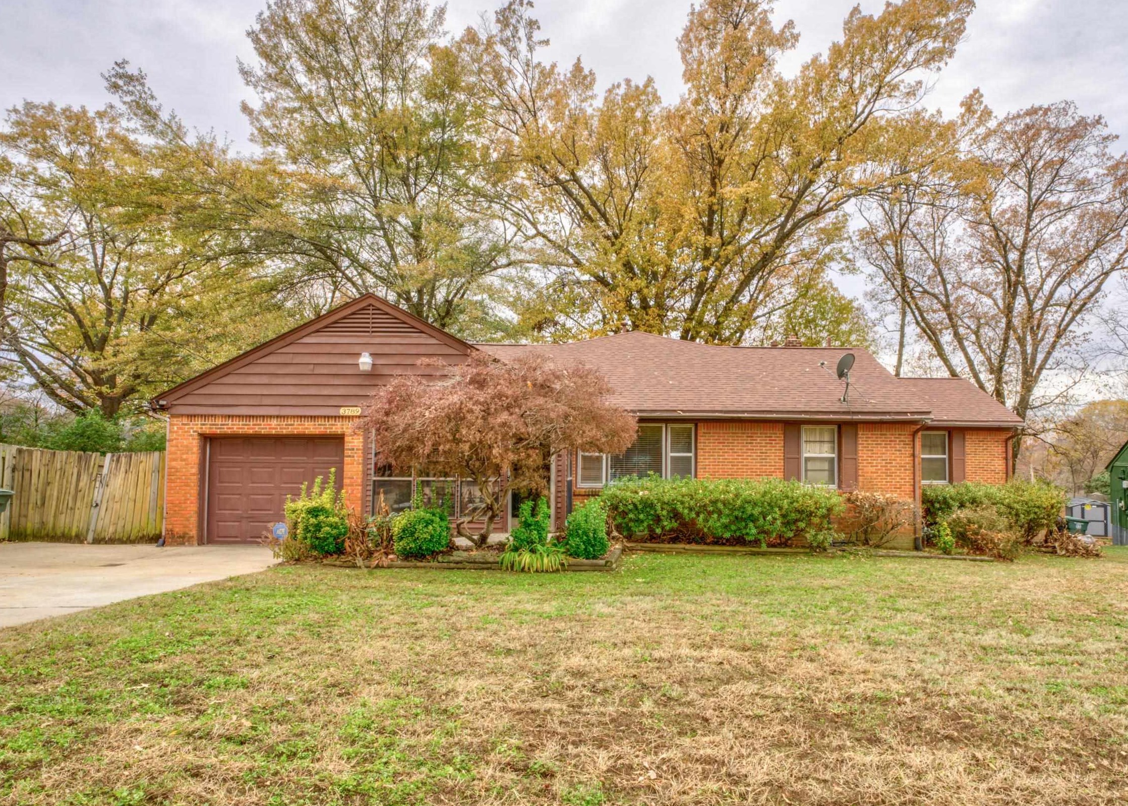 Ranch-style home with a front yard and a garage