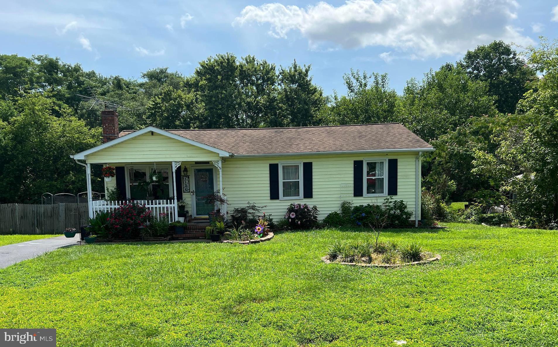 a front view of a house with a yard and porch