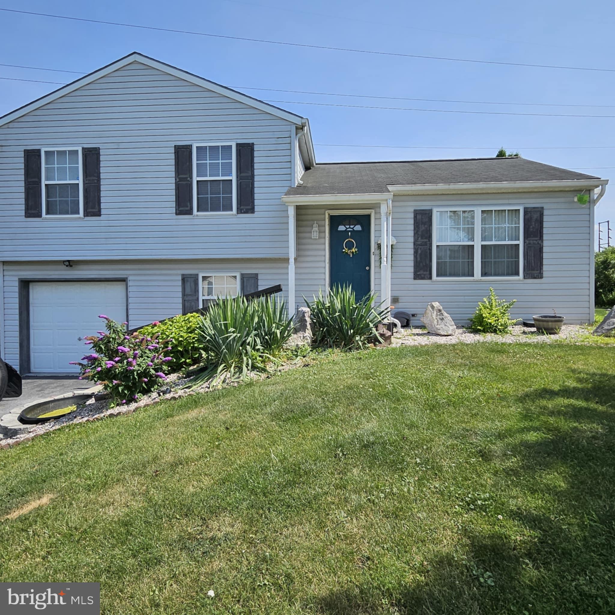 a front view of house and yard with green space