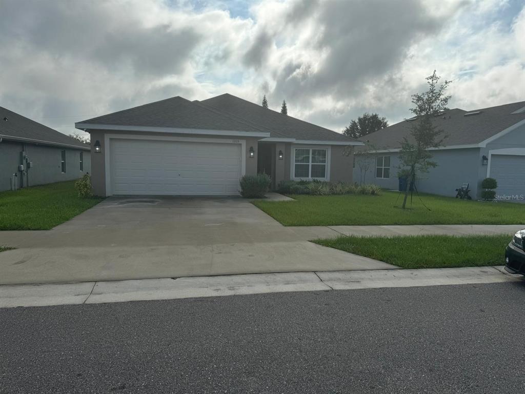 a front view of a house with a yard and garage