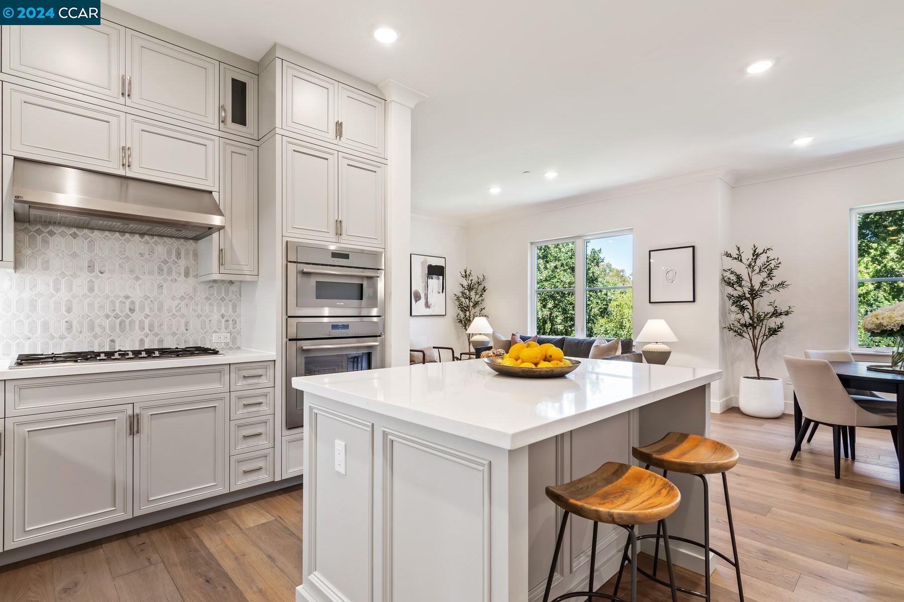 a kitchen with stainless steel appliances a stove a sink and a refrigerator