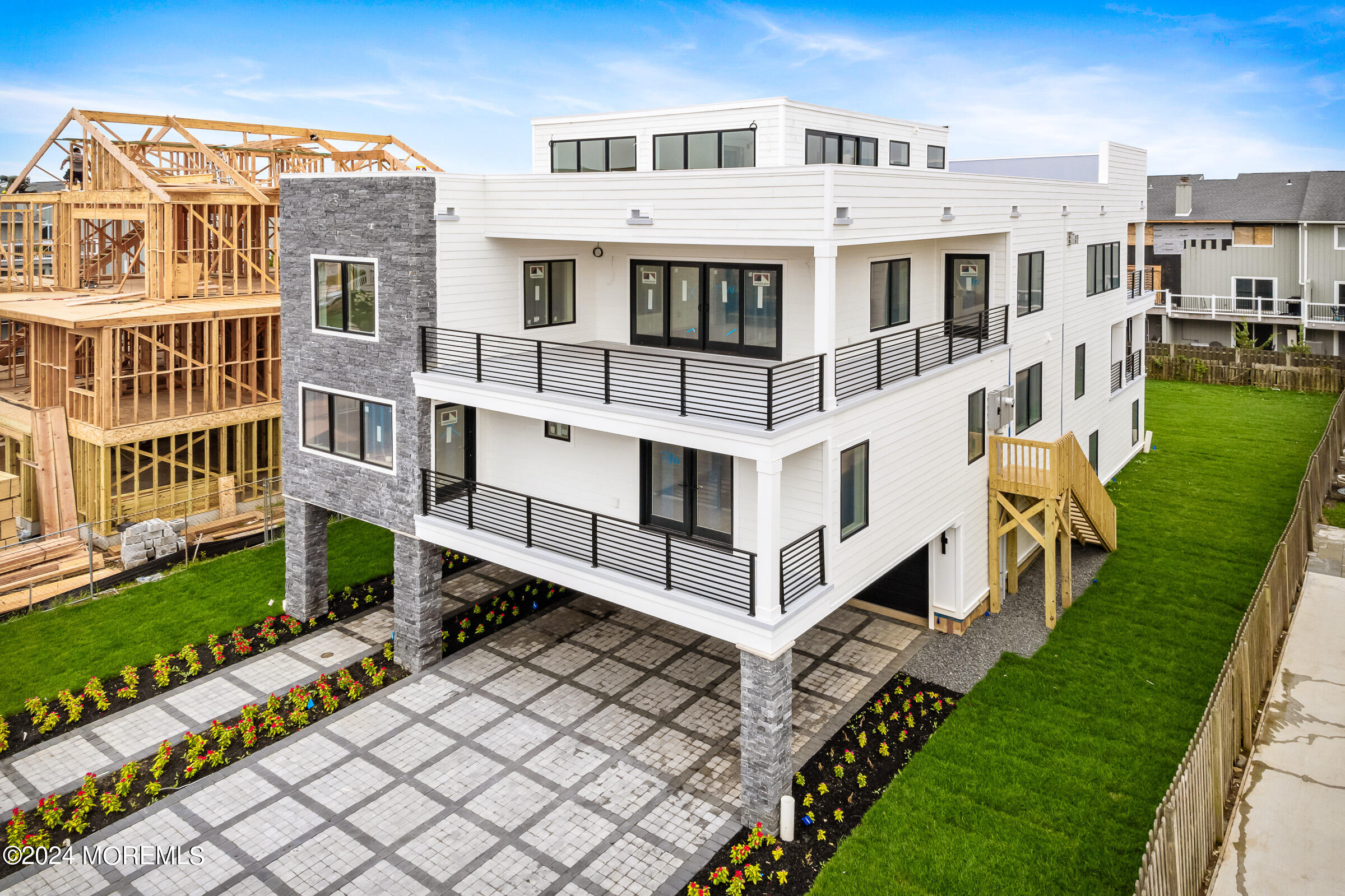 a view of a white building with a big yard