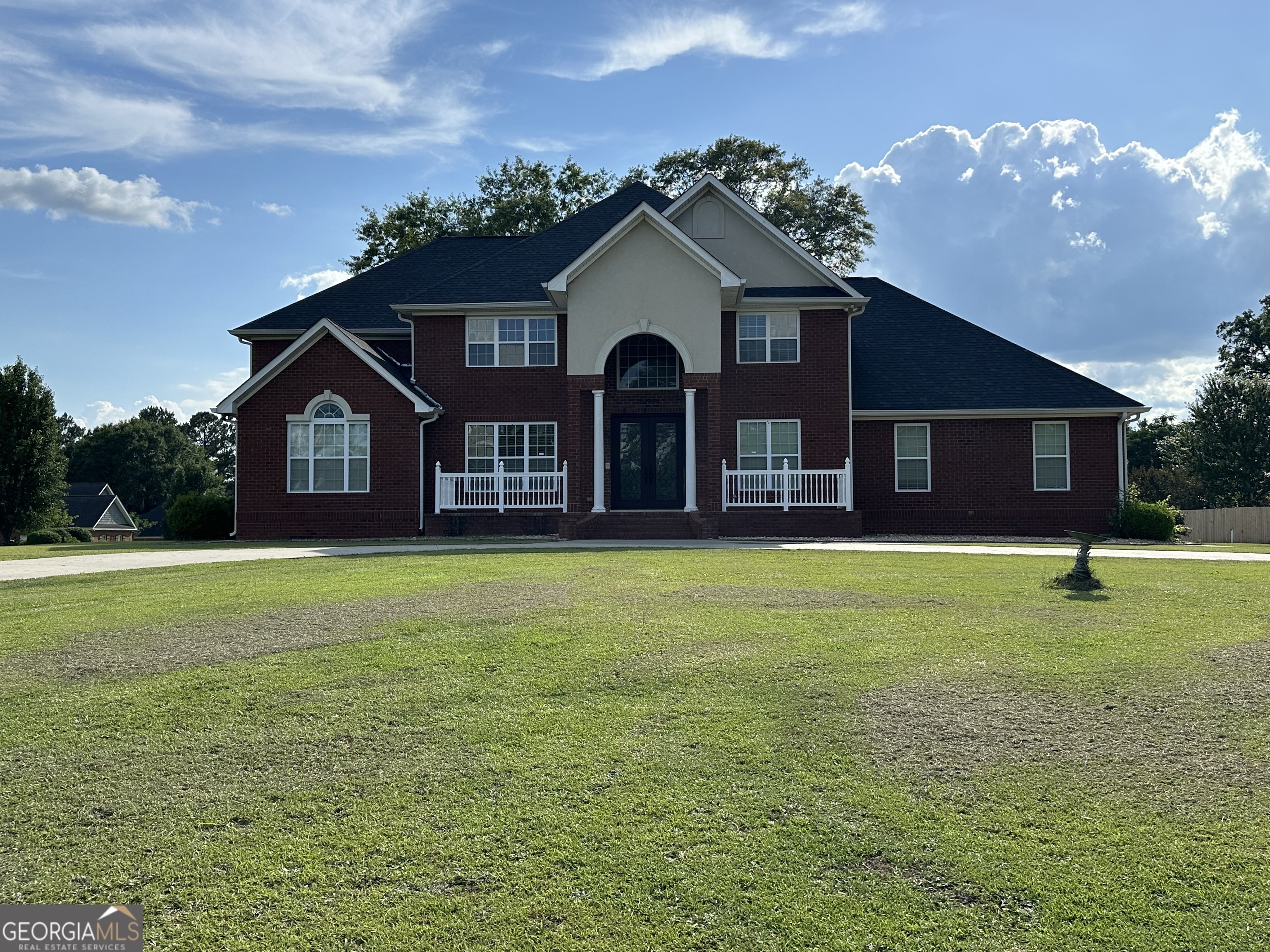 a front view of a house with garden