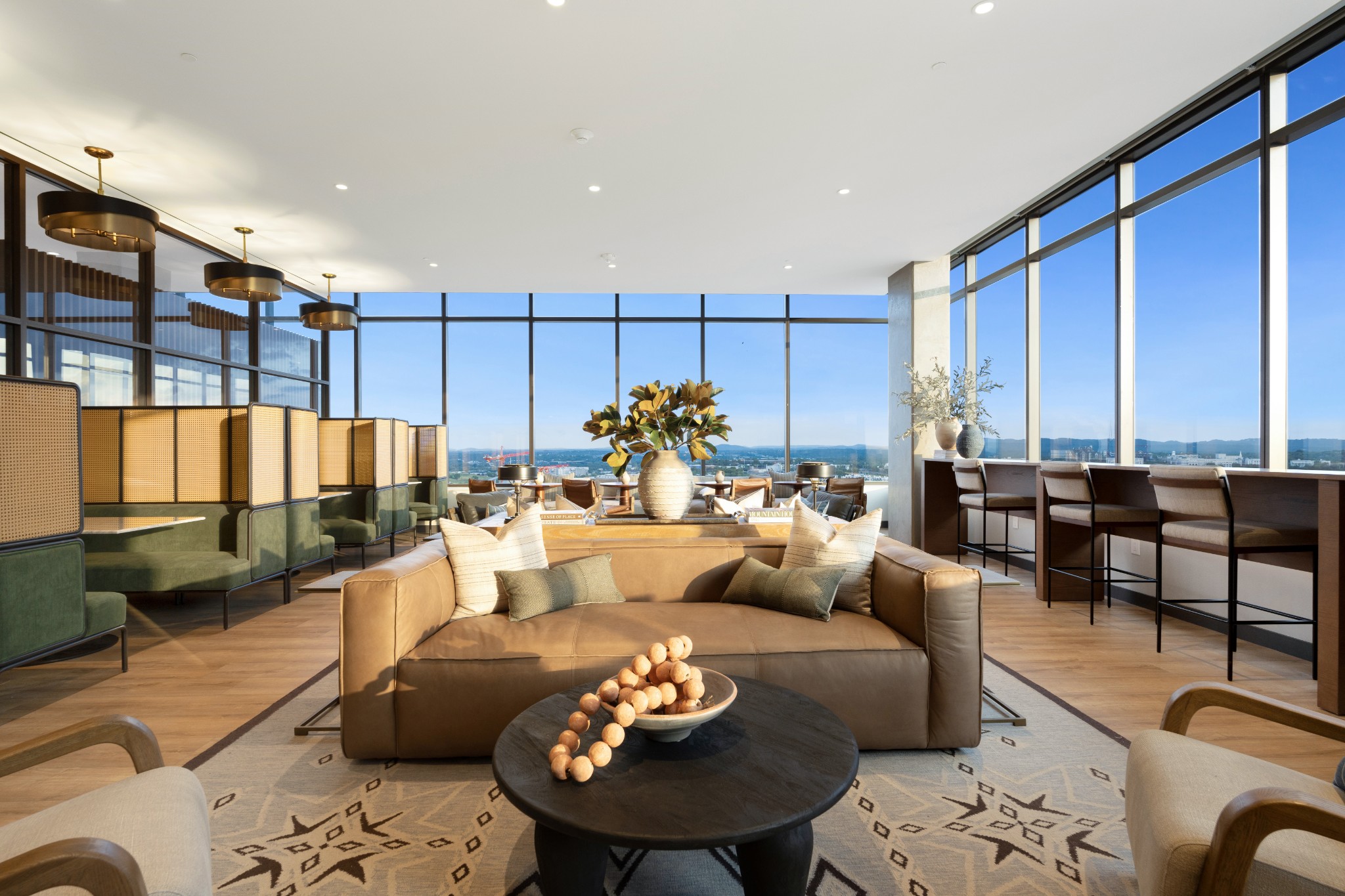 a living room with furniture kitchen view and a large window