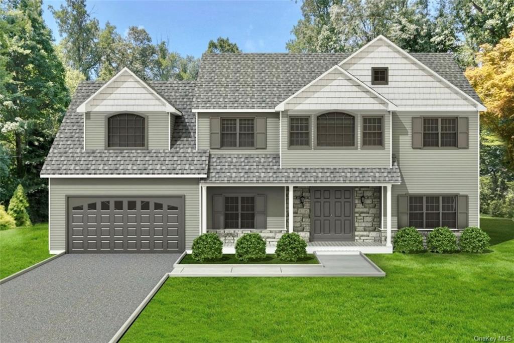 View of front facade featuring a front lawn, covered porch, and a garage