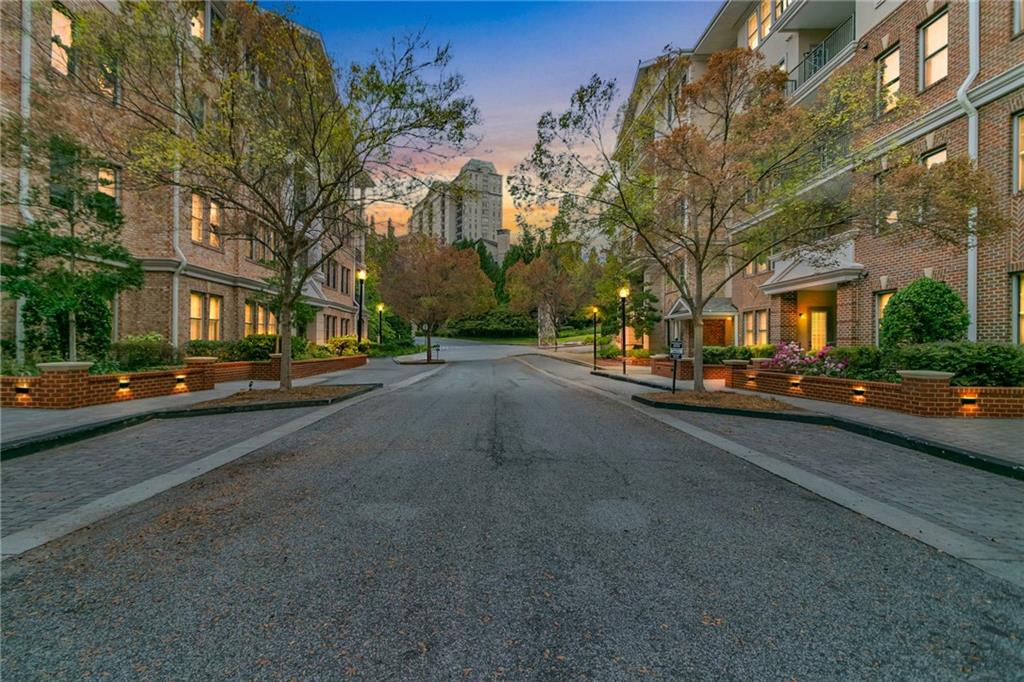 a city street lined with buildings and trees