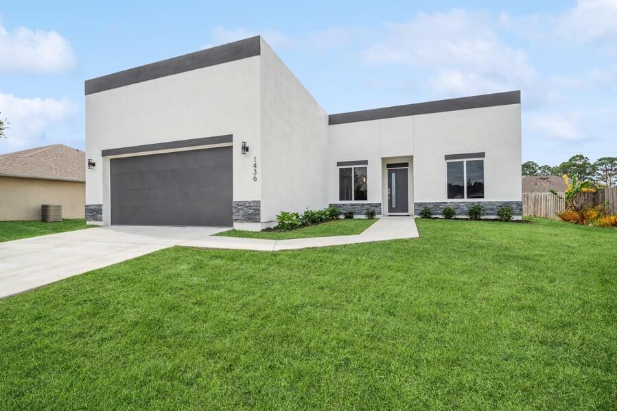 a front view of house with yard and green space