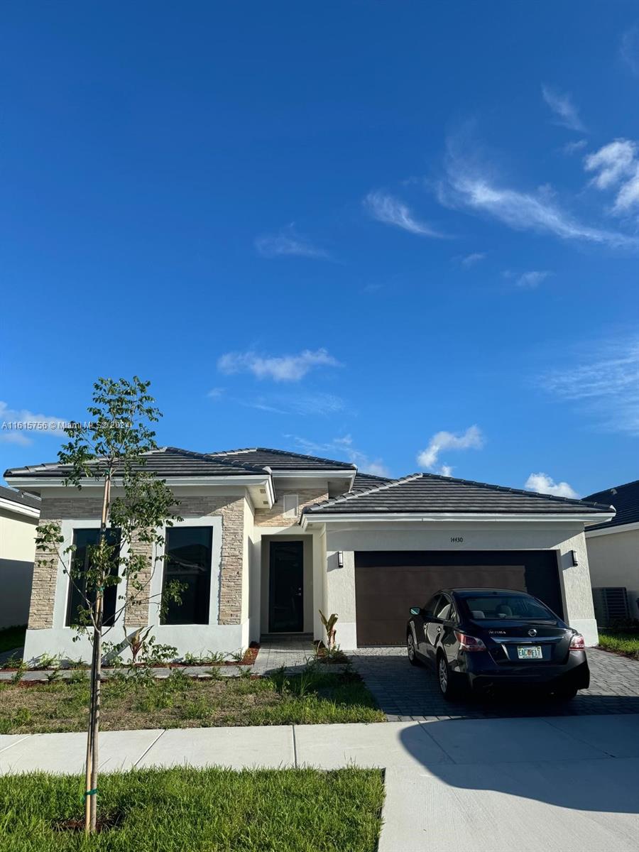 a front view of a house with a yard