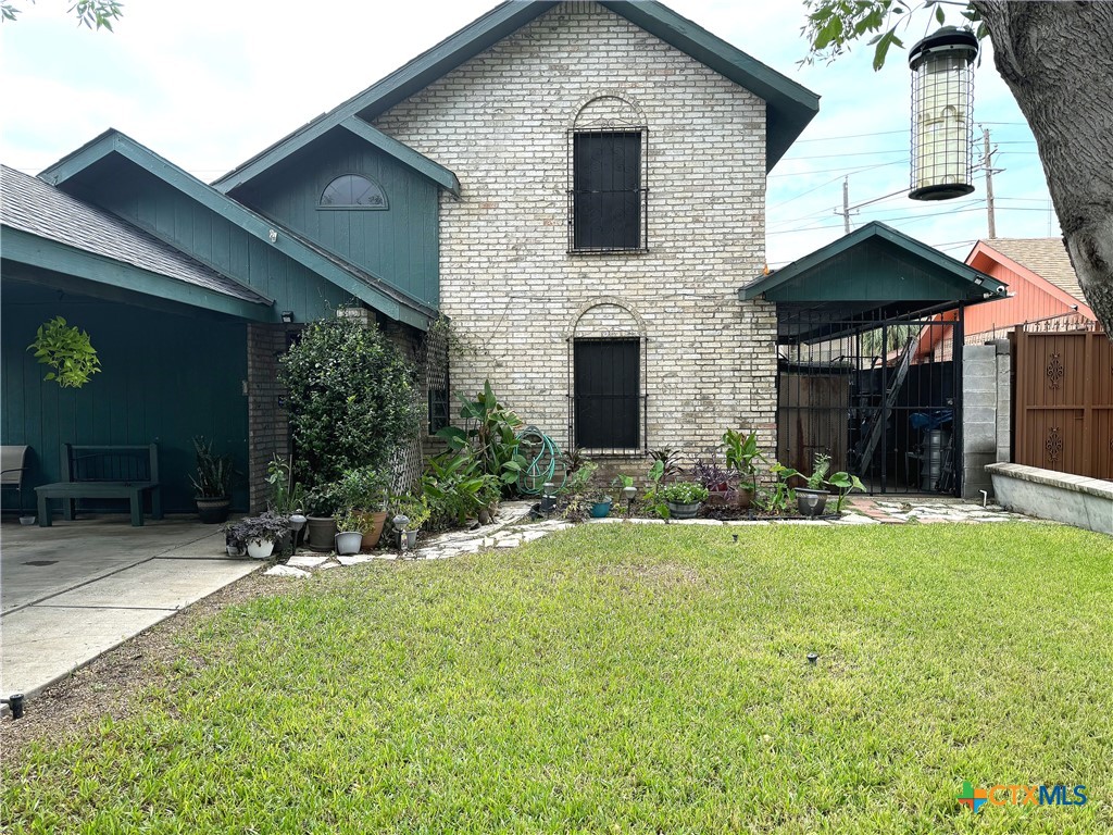 a view of house with yard outdoor seating and entertaining space