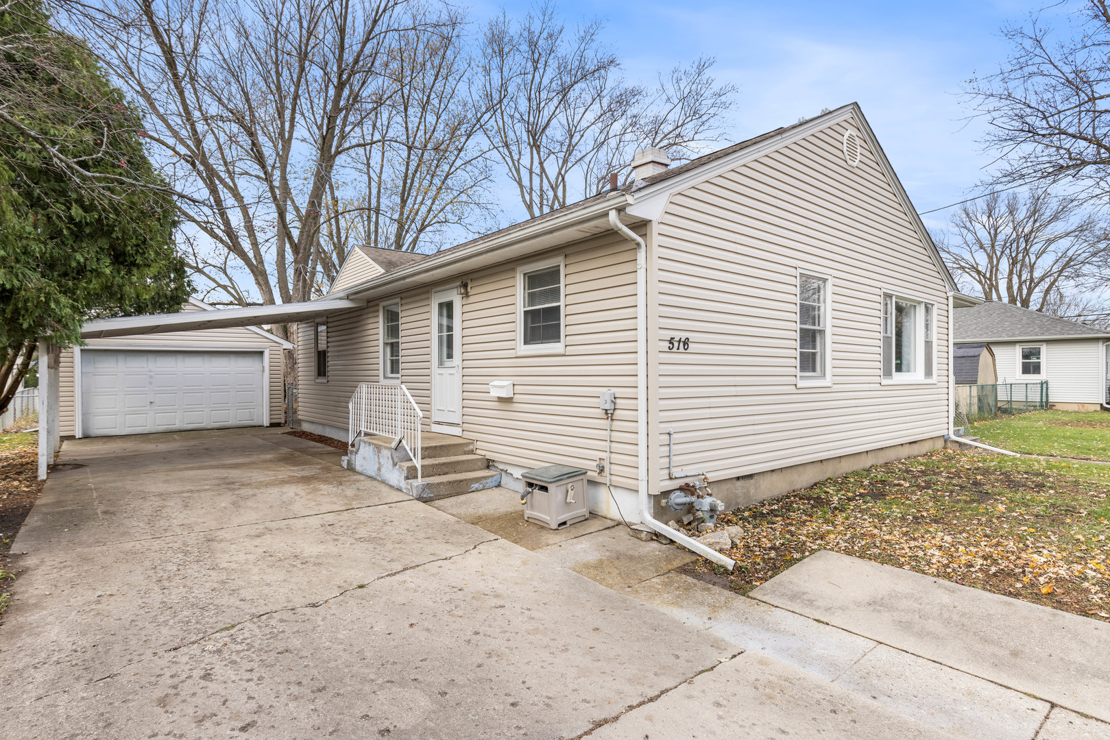 a view of a house with a yard and garage