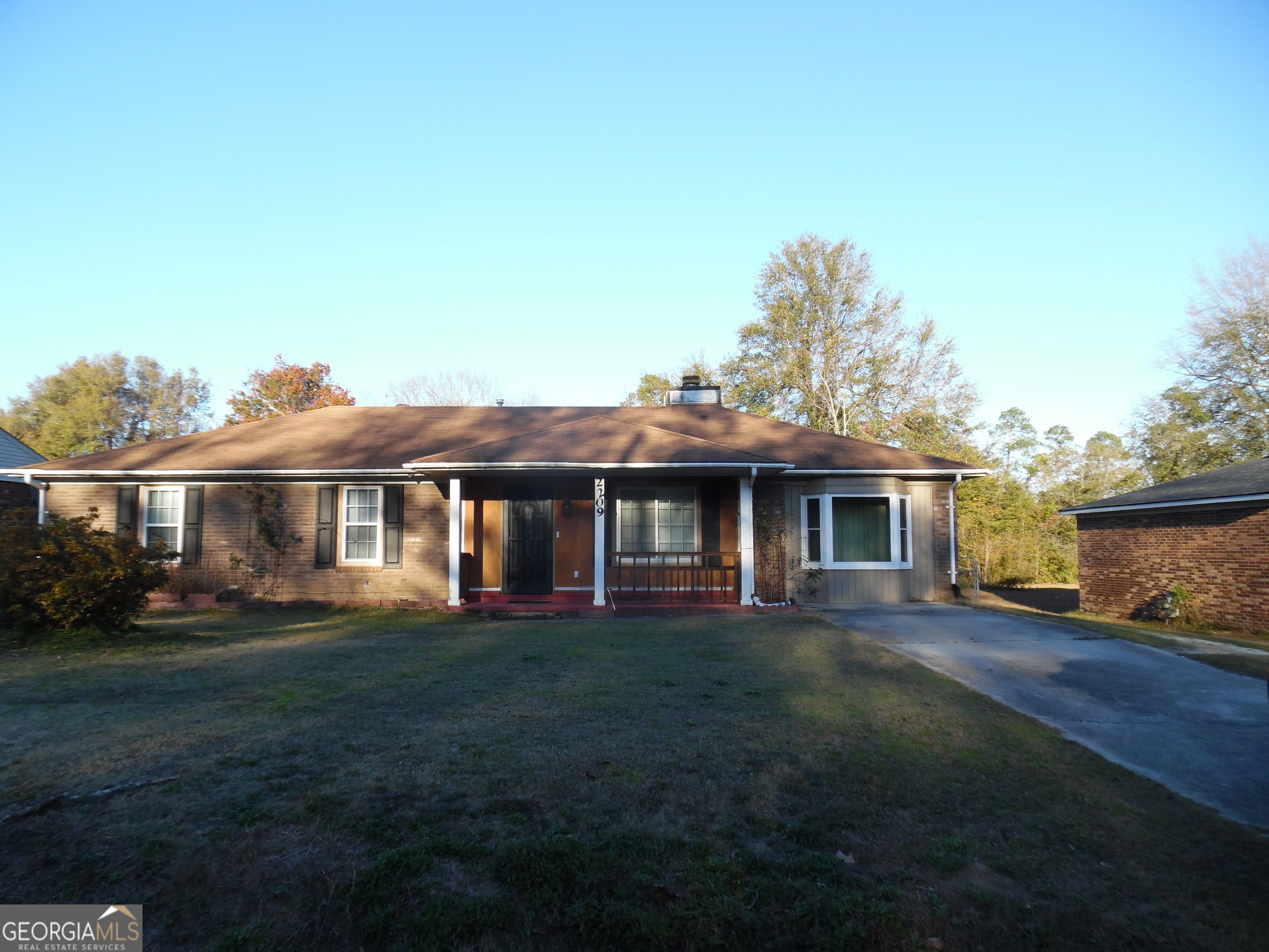 a front view of a house with a garden