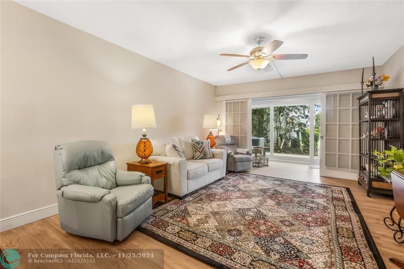 Living/dining room, enclosed patio showing, new vinyl floors &  impact sliding doors