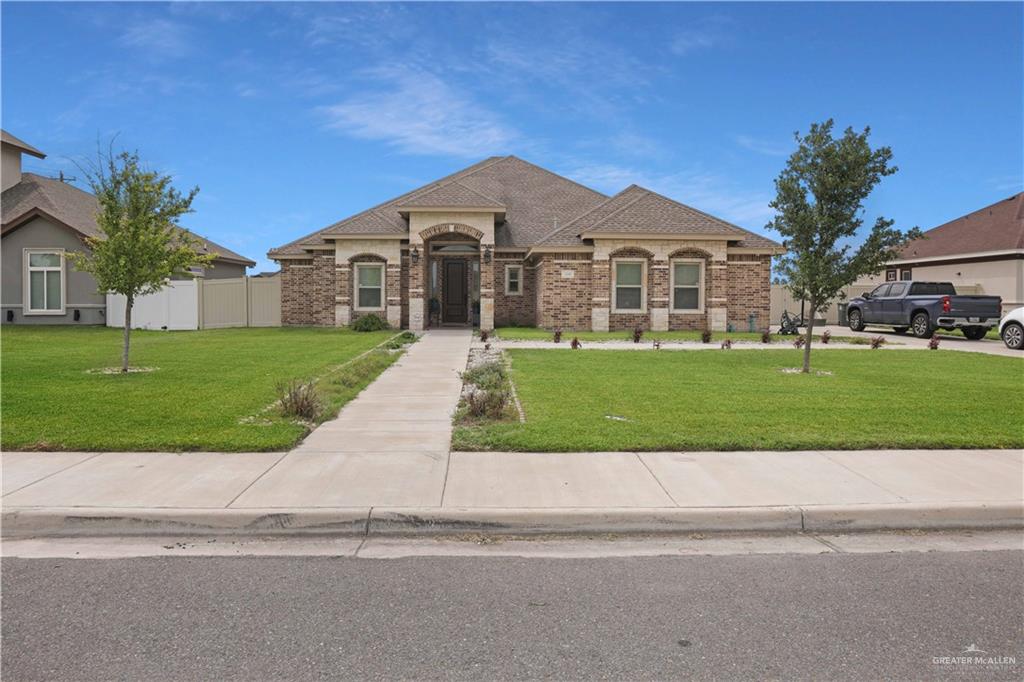 a front view of a house with a yard