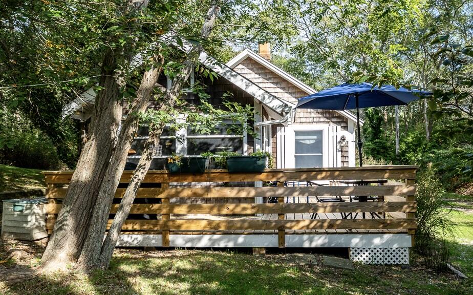 a view of a house with backyard porch and sitting area