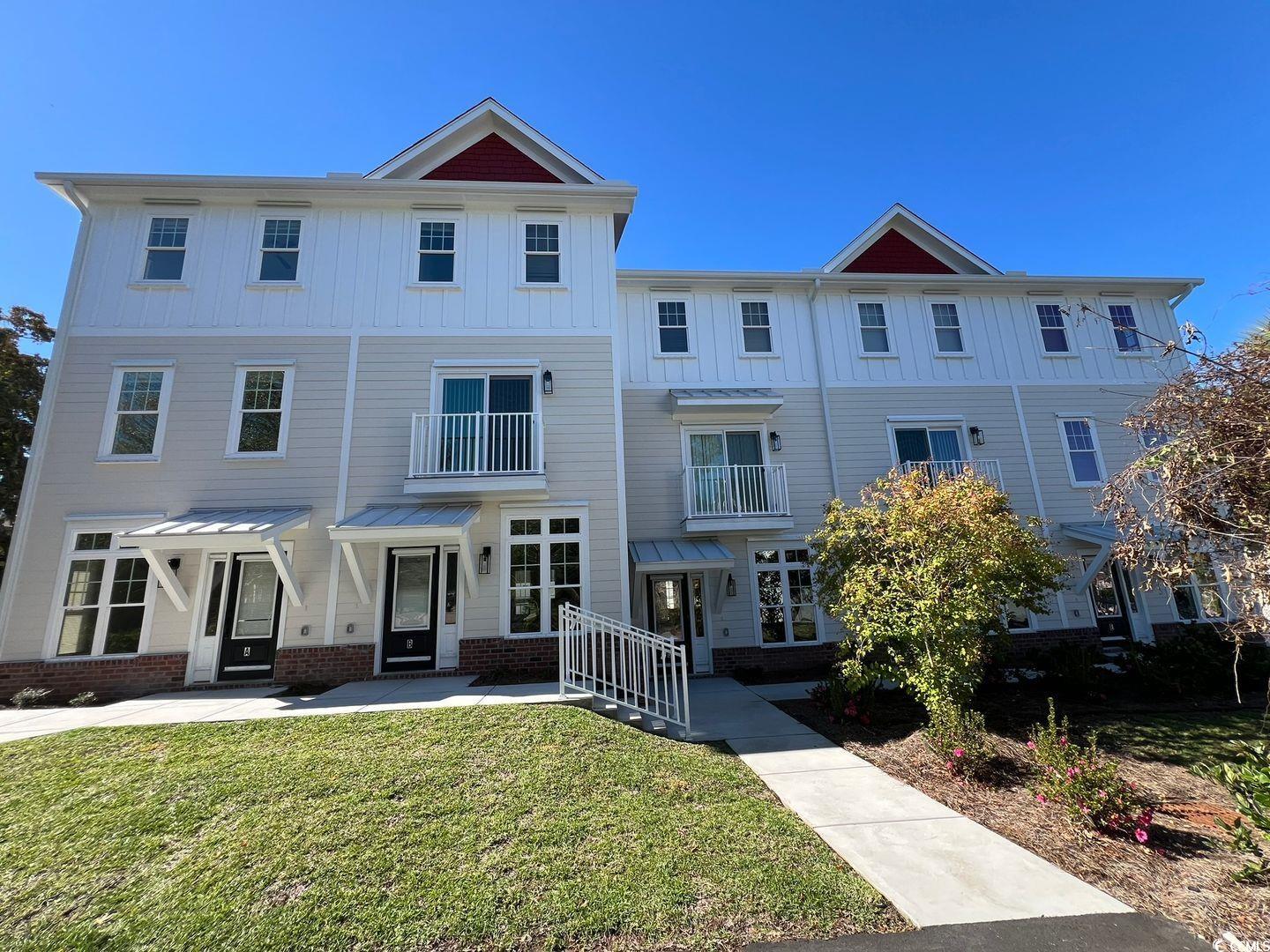 View of front of property with a front yard and a