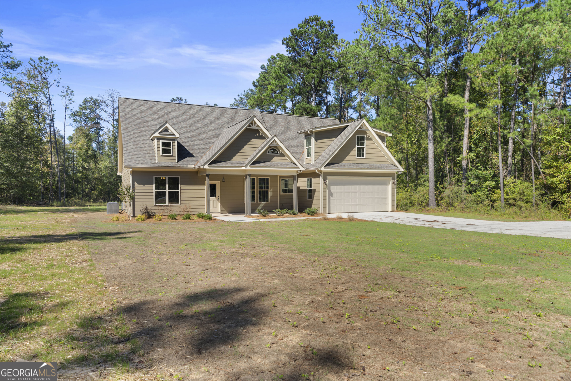 a front view of a house with a garden