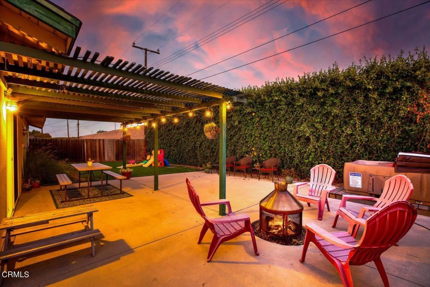 a patio with glass top table and chairs