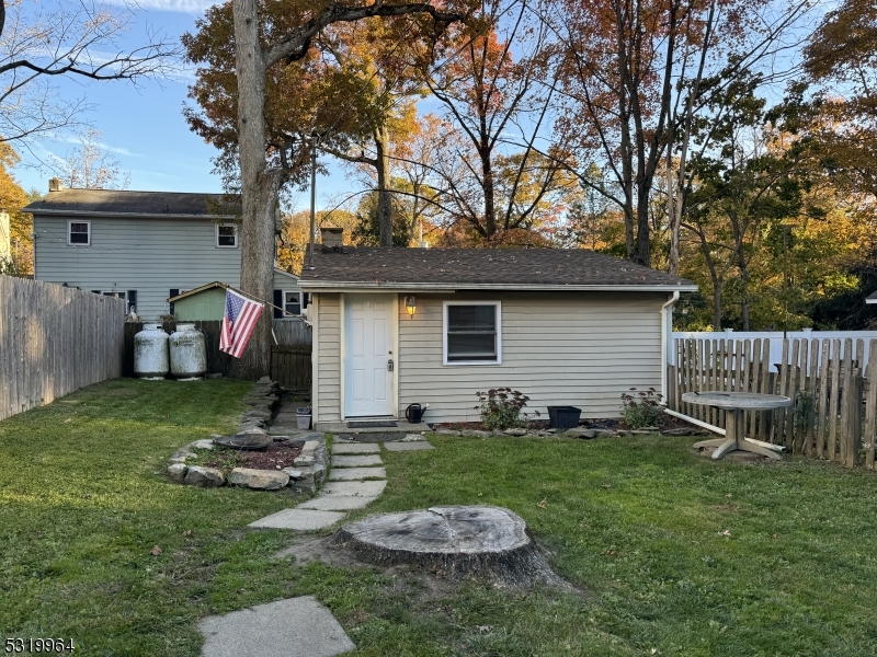 a view of a backyard with table and chairs and a fire pit