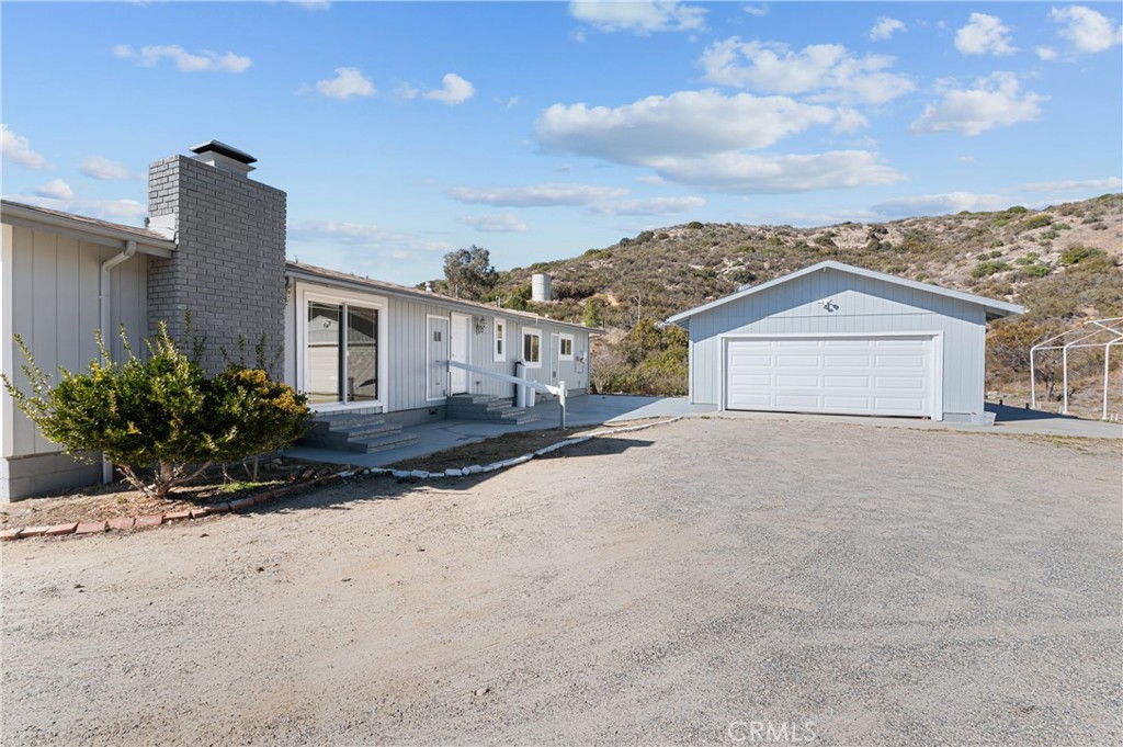 a view of a house with a yard and fence