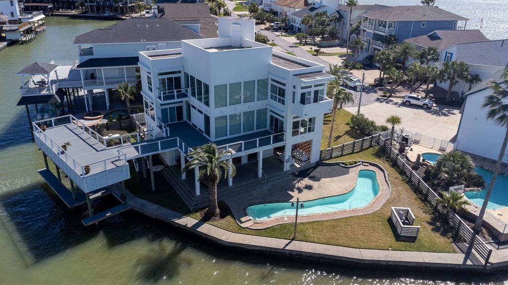 an aerial view of a house with a yard basket ball court and lake view