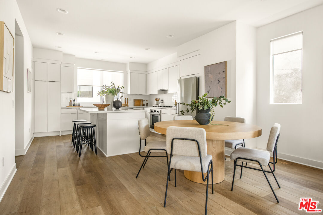 a dining room with furniture and wooden floor