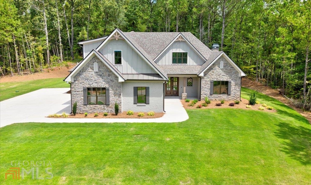 a front view of a house with a yard patio and green space