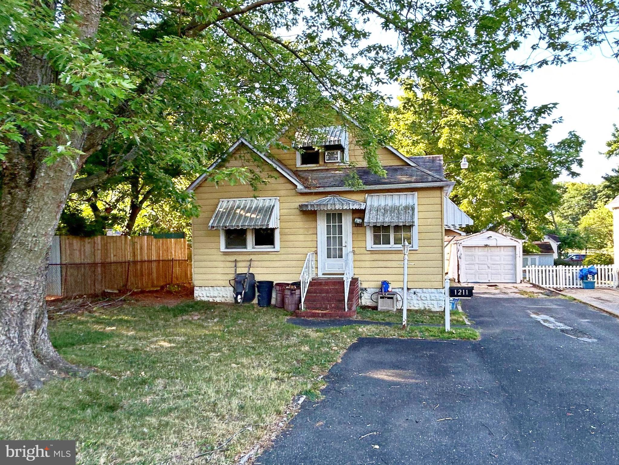 a front view of a house with a yard and fence