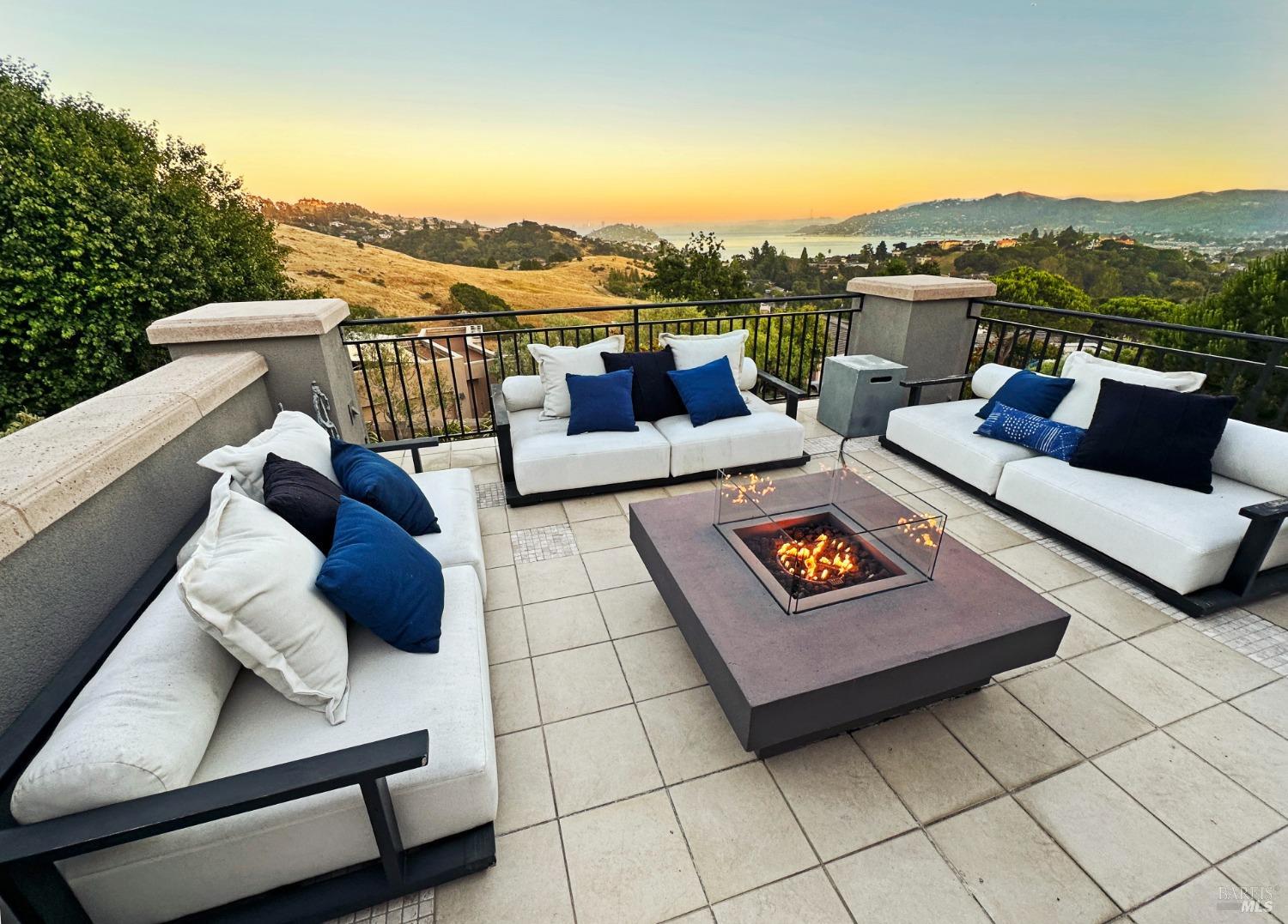 a view of a roof deck with couches and potted plants