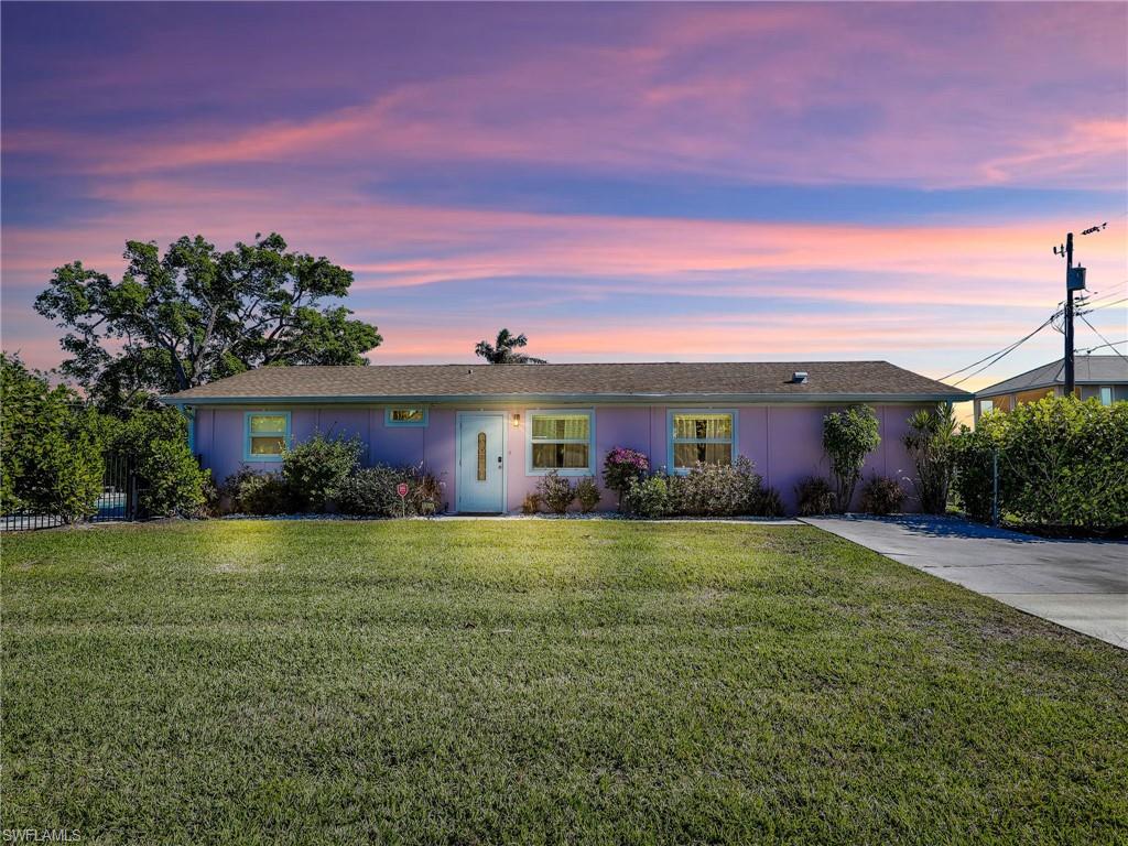 a view of a house with a yard and garage