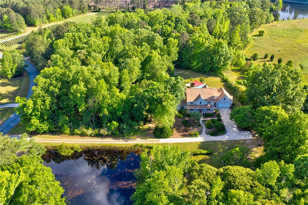 an aerial view of a house with a yard basket ball court and outdoor seating