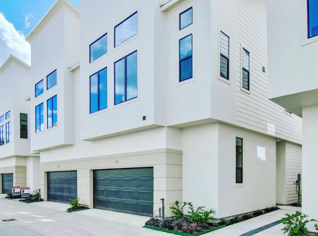 a front view of a house with garage