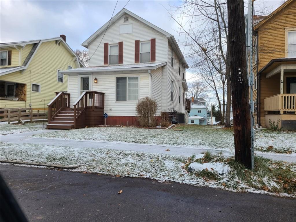 a view of a car parked front of a house