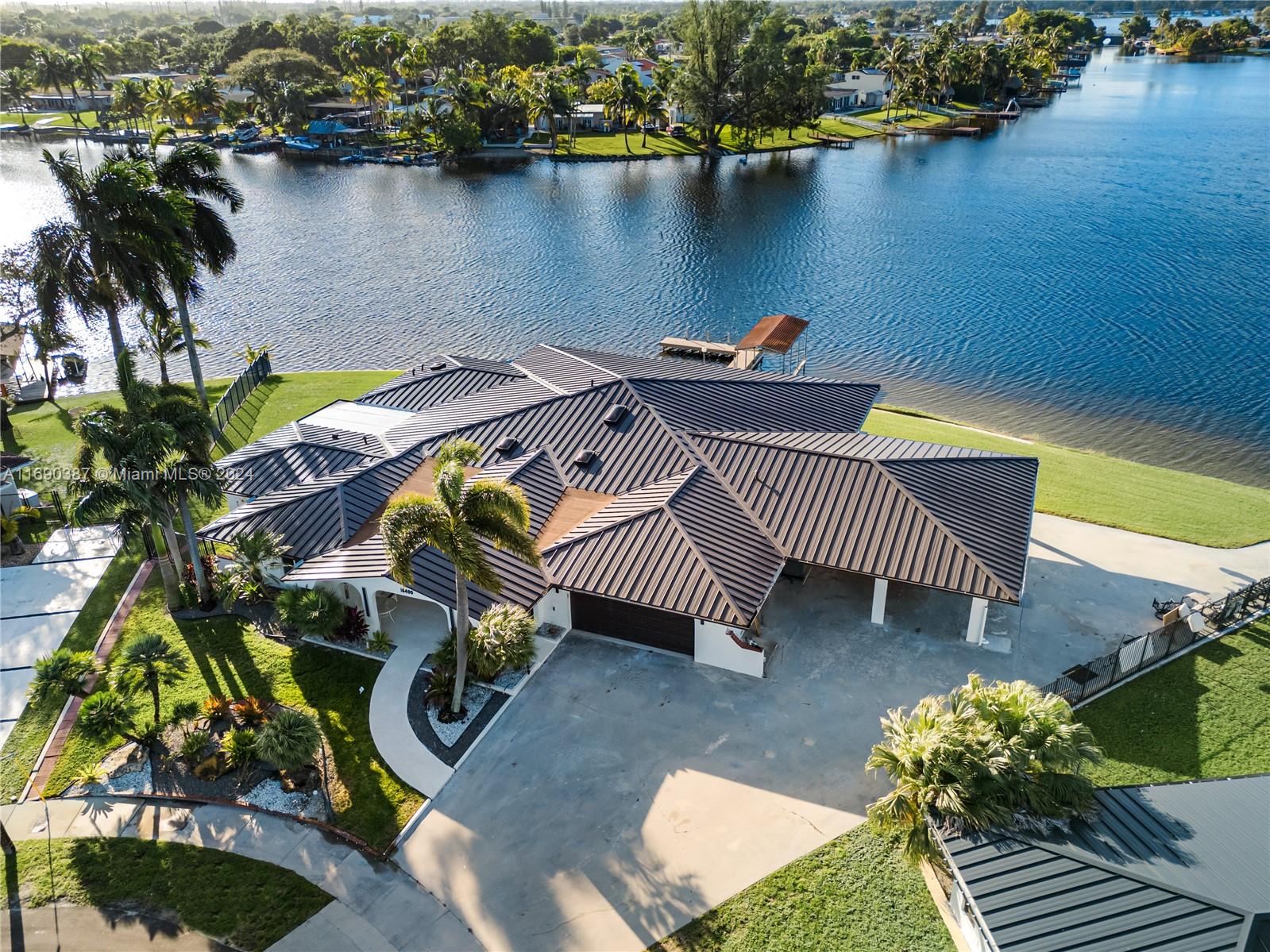 an aerial view of a house with swimming pool and patio