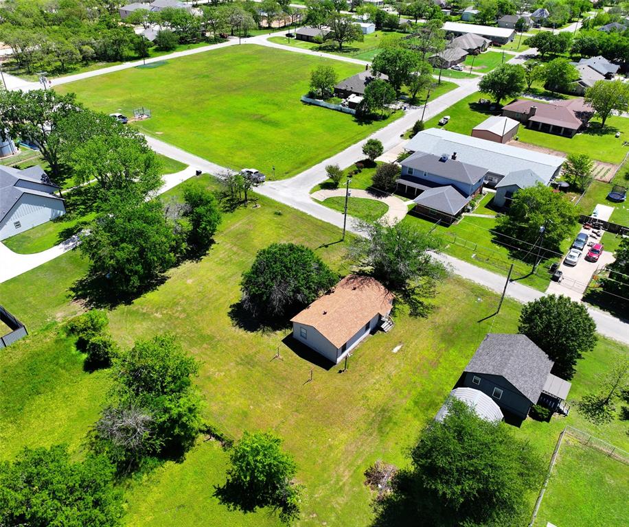 an aerial view of residential house with an outdoor space and street view