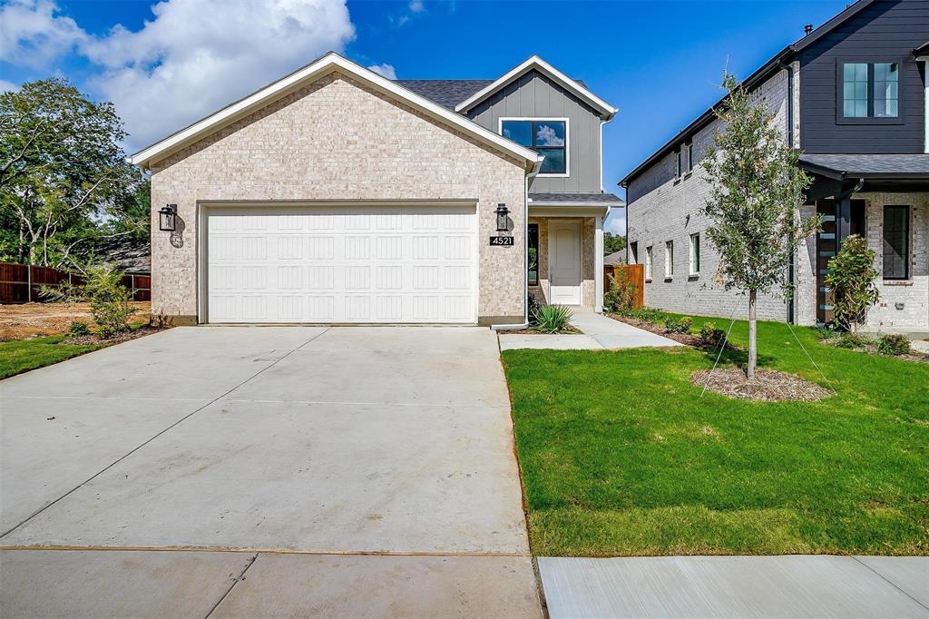 a view of a house with a yard and garage