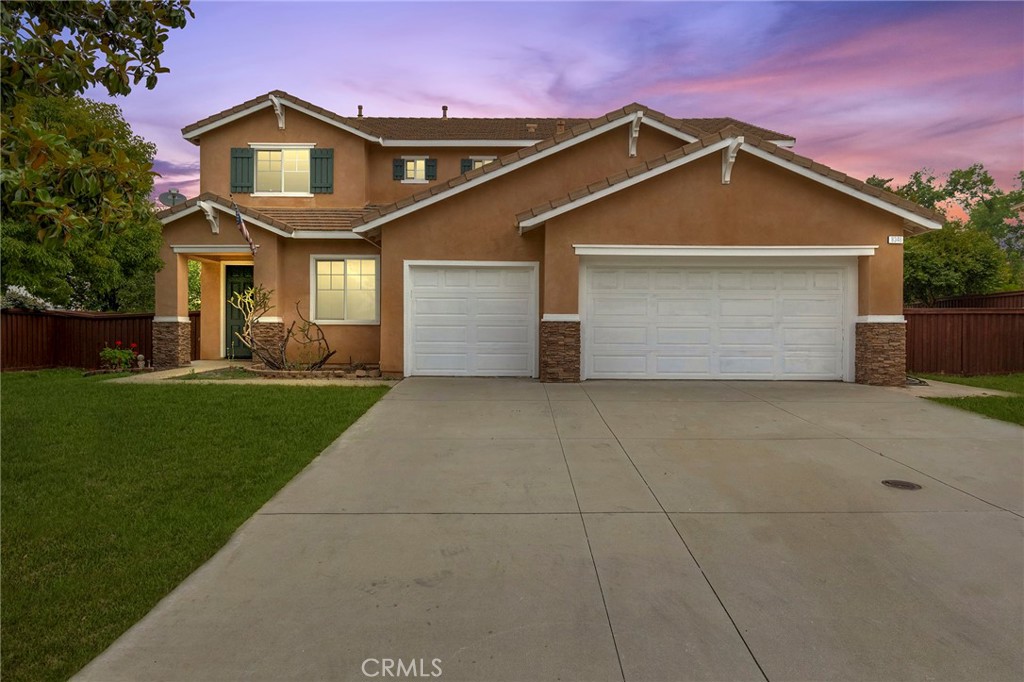 a front view of a house with a yard and garage