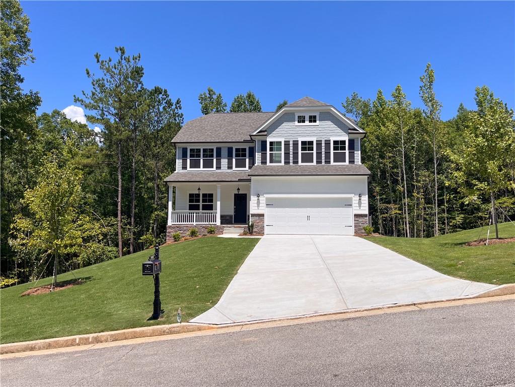 a front view of a house with a garden