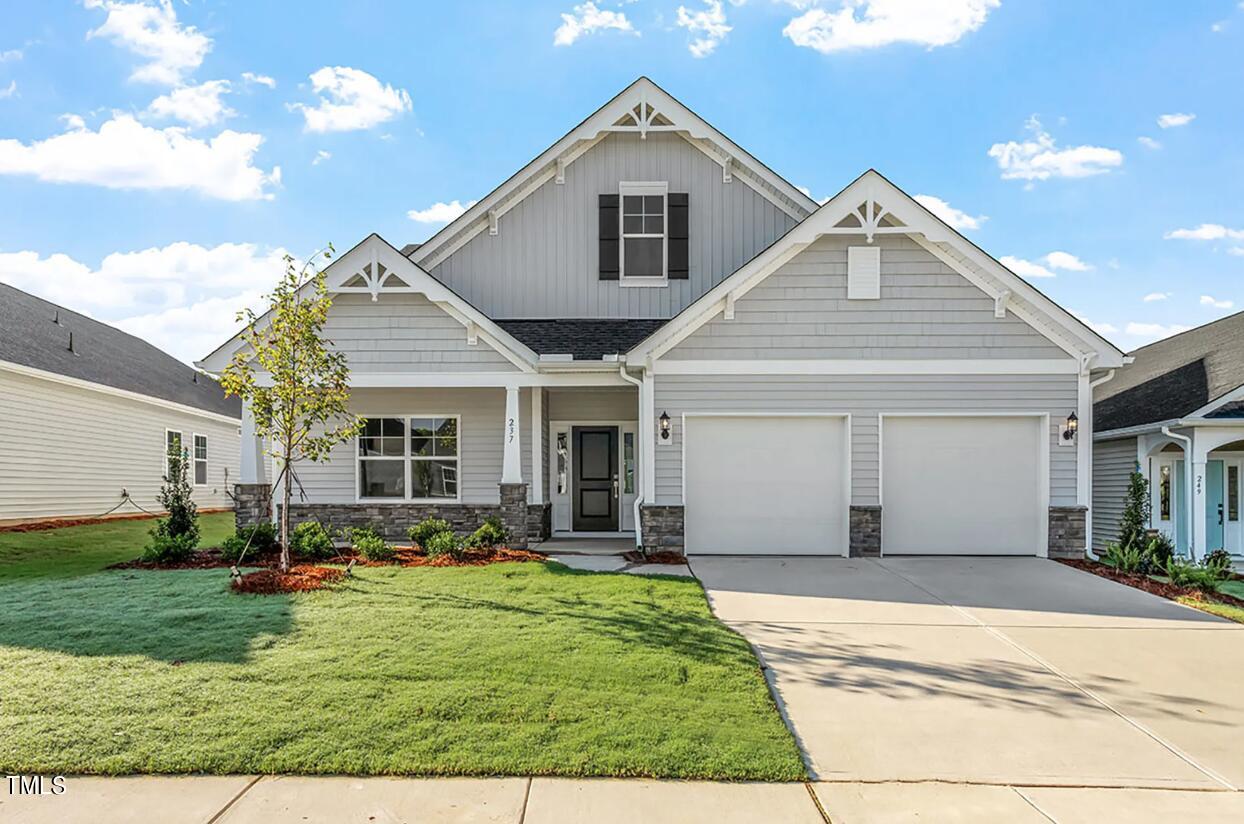 a front view of a house with a yard and outdoor seating