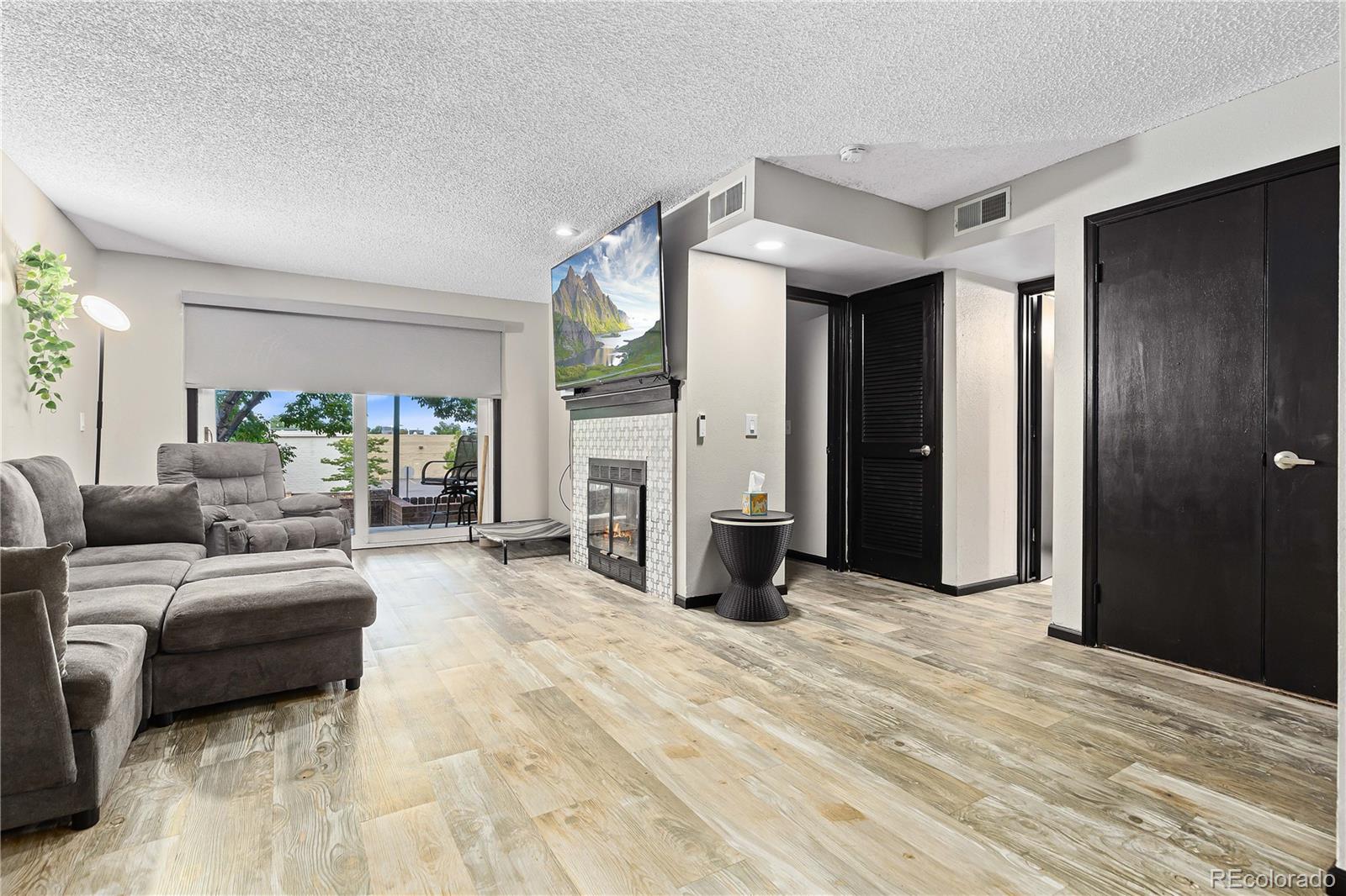 a living room with furniture a large window and a walk in closet