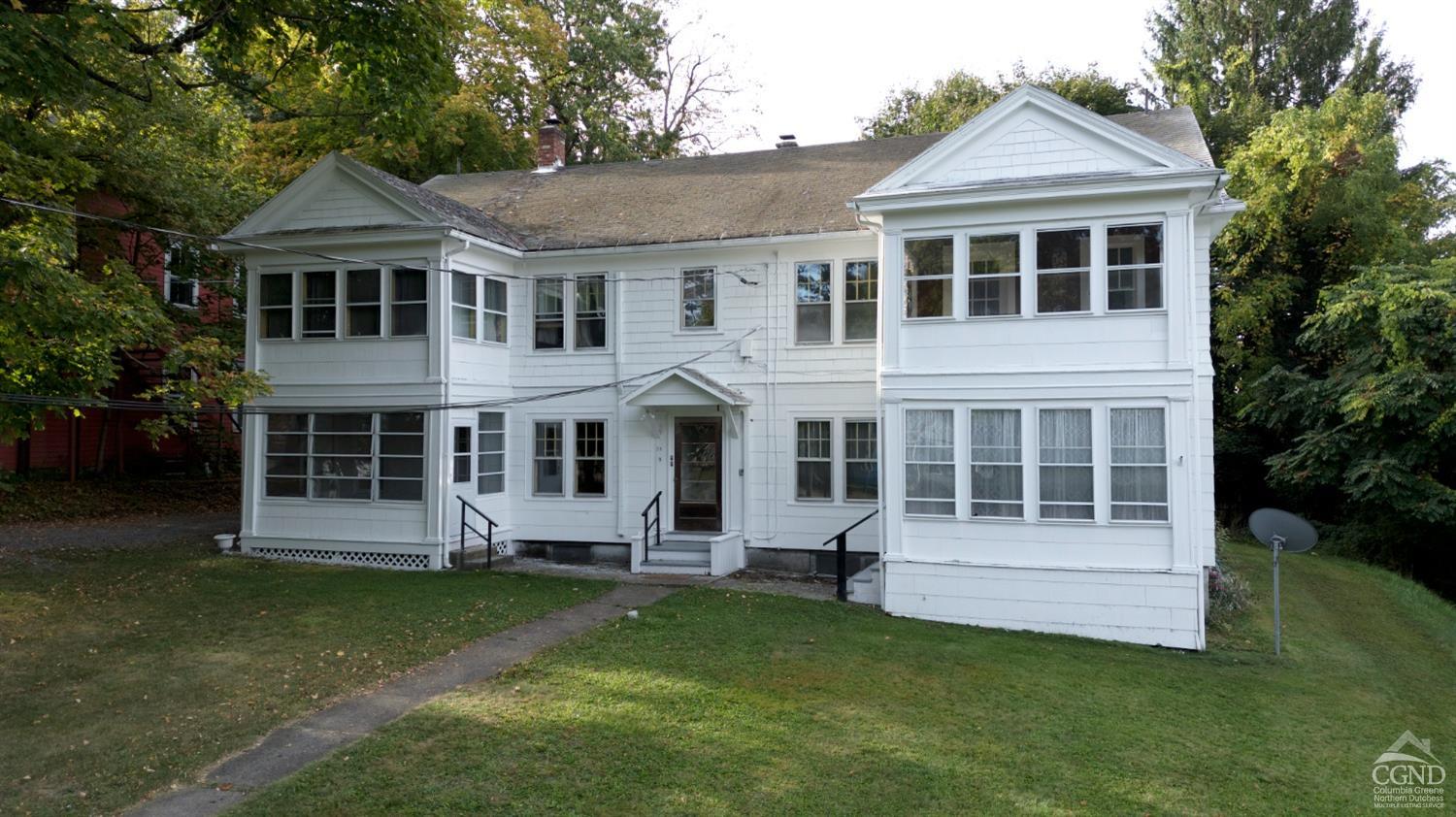 a front view of a house with a yard