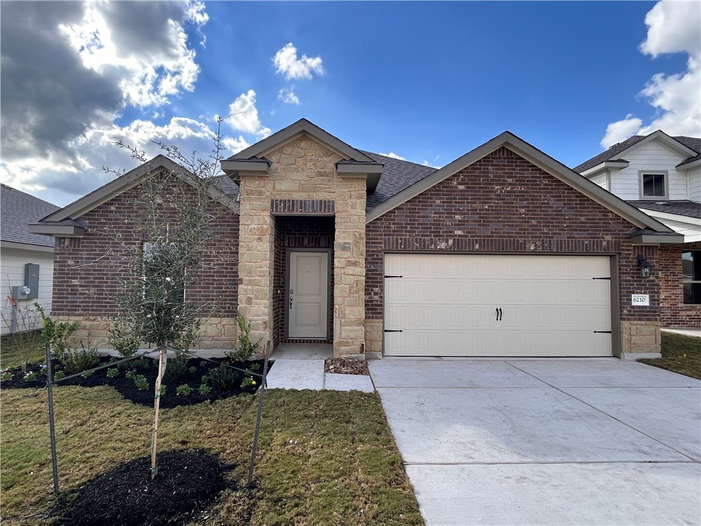 View of front of property with a garage and a fron