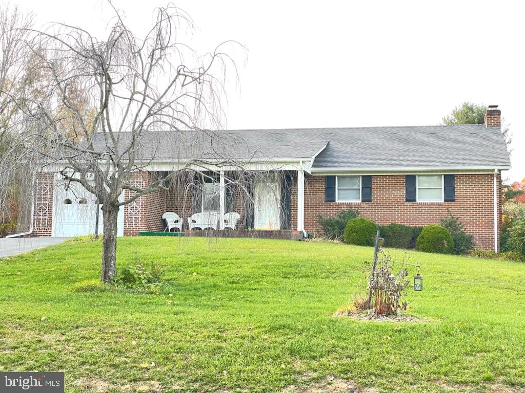 a front view of house with a garden and trees