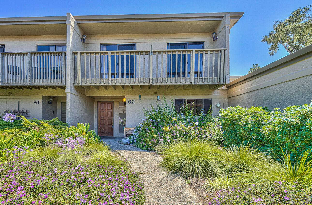 a view of a house with a flower garden