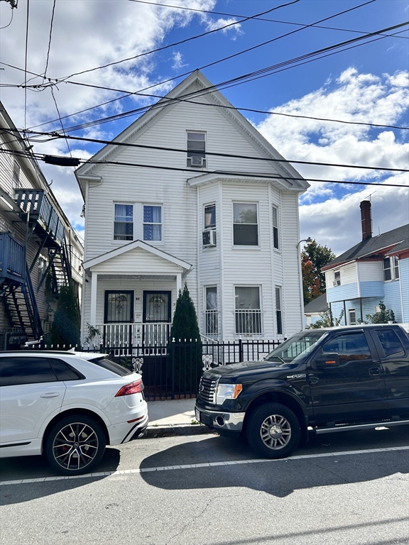 a front view of a house with parking space