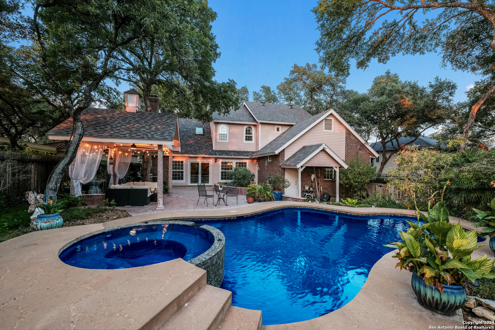 a view of house with swimming pool and furniture