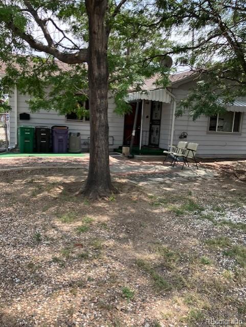 a front view of a house with a tree