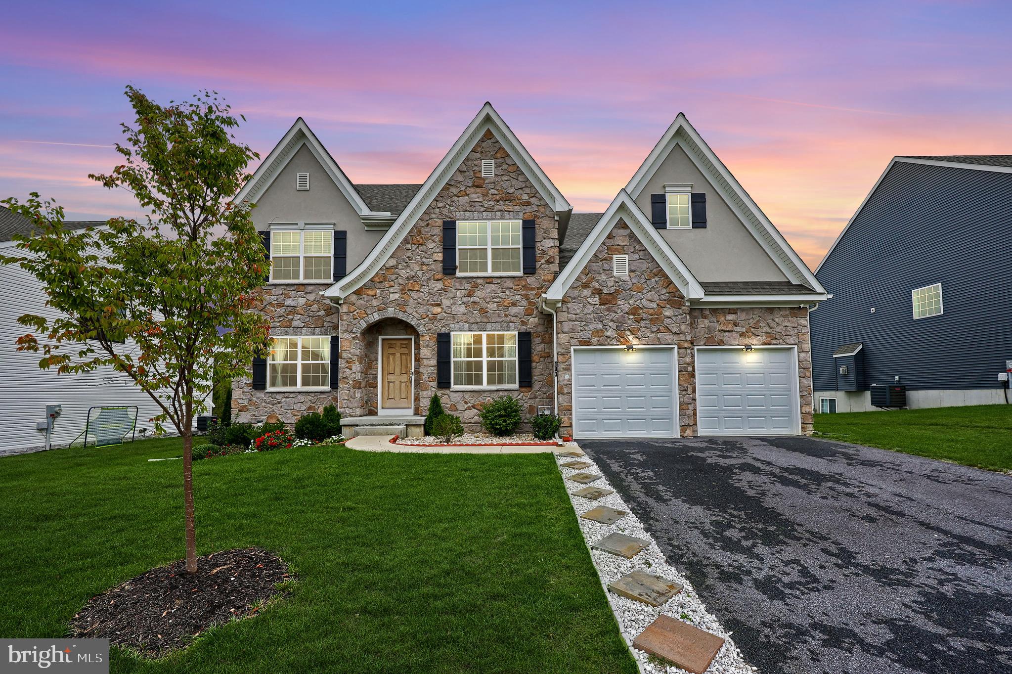 a front view of a house with a yard and garage